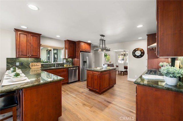 2465 Via Oeste Dr, Fallbrook, CA 92028 - kitchen featuring appliances with stainless steel finishes, a sink, arched walkways, a center island, and backsplash
