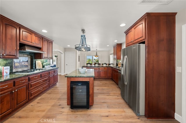 2465 Via Oeste Dr, Fallbrook, CA 92028 - kitchen featuring stainless steel appliances, beverage cooler, under cabinet range hood, arched walkways, and recessed lighting