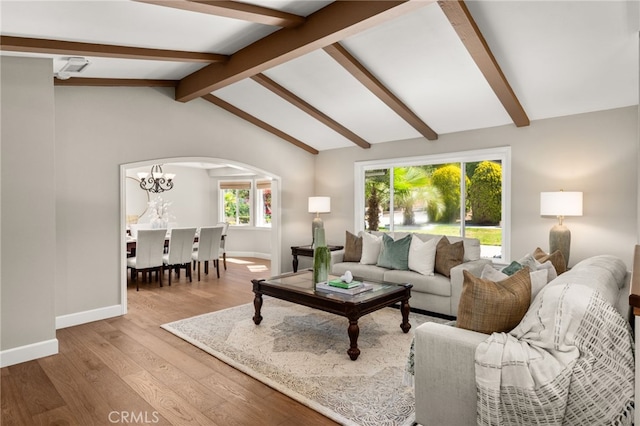 2465 Via Oeste Dr, Fallbrook, CA 92028 - living area with wood finished floors, arched walkways, baseboards, and a chandelier