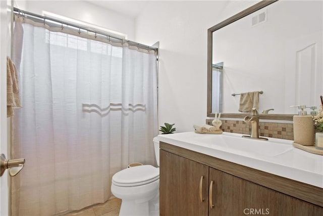 full bathroom with visible vents, vanity, toilet, tile patterned floors, and tasteful backsplash