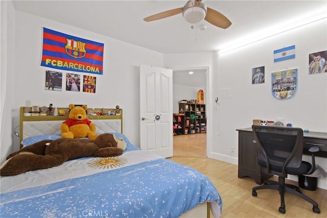bedroom with baseboards, a ceiling fan, and wood finished floors