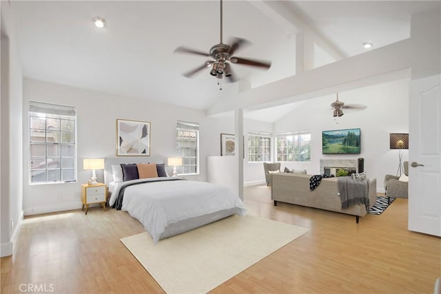 bedroom with baseboards, light wood-style flooring, high vaulted ceiling, and beamed ceiling