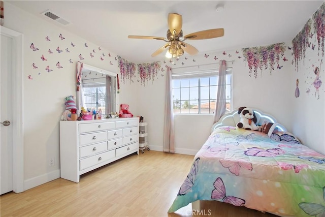 bedroom with visible vents, a ceiling fan, light wood-style floors, and baseboards