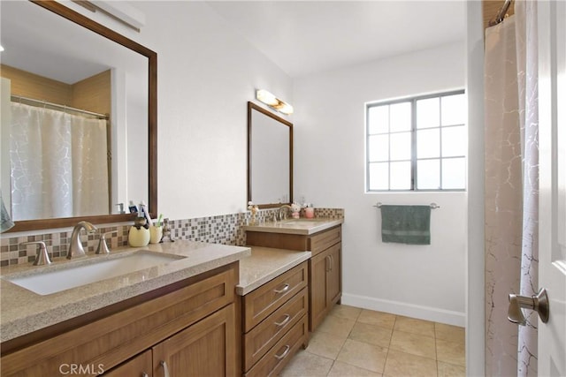 full bathroom with vanity, tile patterned floors, baseboards, and backsplash
