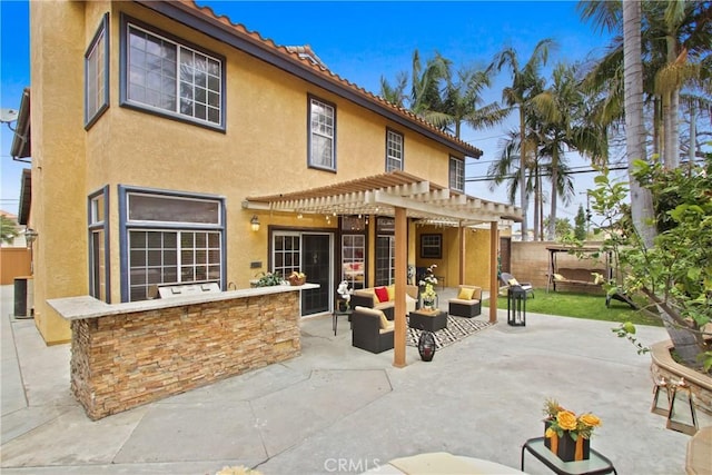 back of property featuring a patio, outdoor lounge area, stucco siding, and a pergola