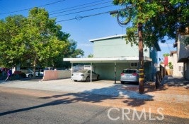 view of front of home with a carport and concrete driveway