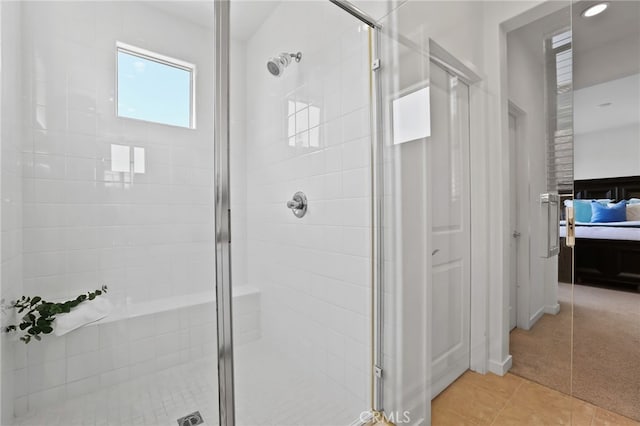 ensuite bathroom featuring tile patterned flooring, ensuite bathroom, and a shower stall