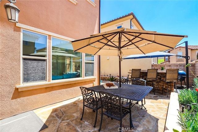 view of patio featuring fence and outdoor dining space