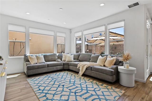 living area featuring recessed lighting, baseboards, visible vents, and wood finished floors