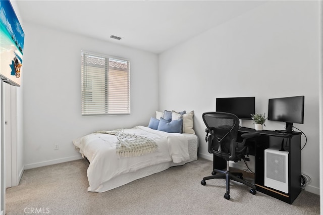 bedroom featuring baseboards, visible vents, and carpet