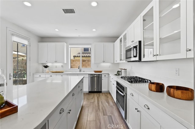 kitchen featuring stainless steel appliances, visible vents, a wealth of natural light, and recessed lighting