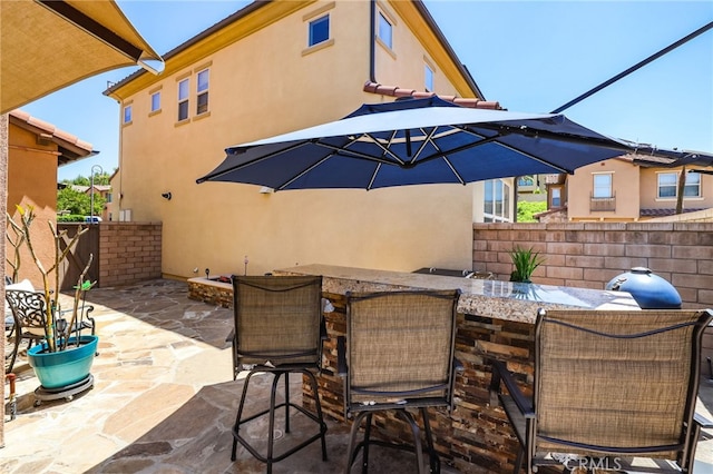 view of patio / terrace with fence and outdoor dry bar