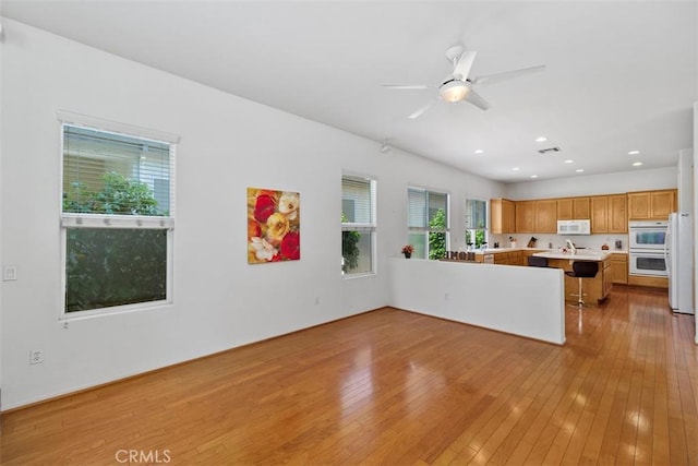 unfurnished living room featuring recessed lighting, ceiling fan, light wood-type flooring, and visible vents