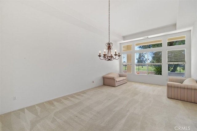 sitting room featuring carpet and a notable chandelier