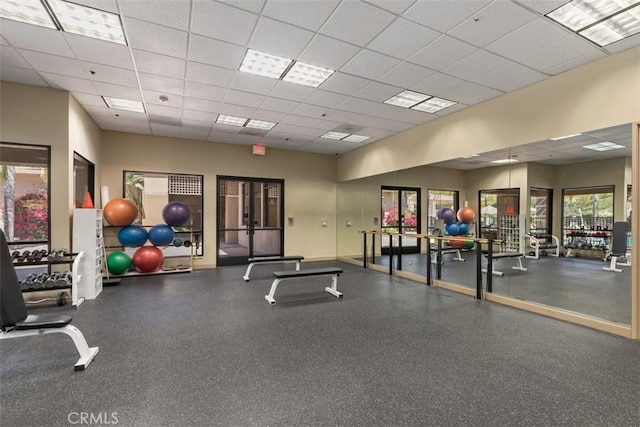 exercise room featuring visible vents and a drop ceiling