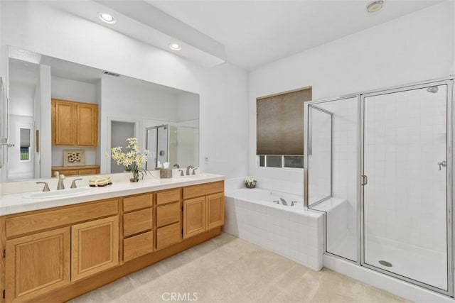 bathroom featuring a sink, a stall shower, a bath, and visible vents