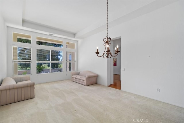 living area featuring visible vents, a tray ceiling, a chandelier, and carpet