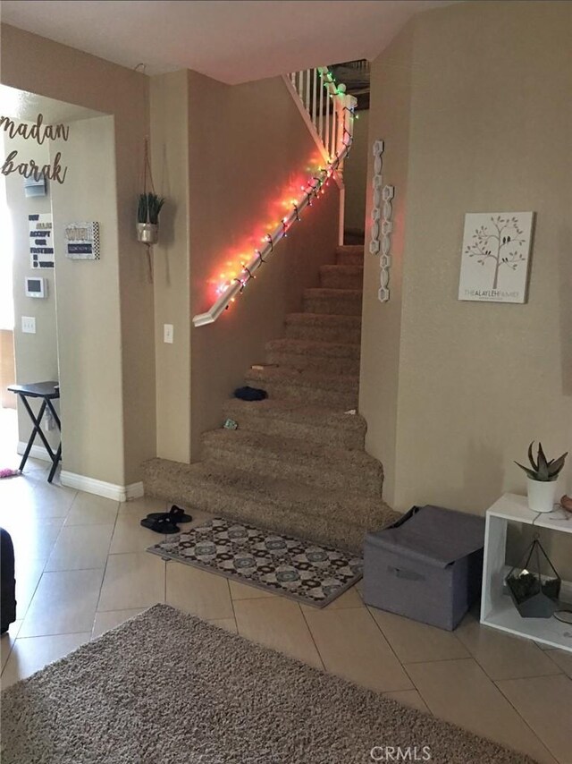 12369 Kern River Dr, Eastvale, CA 91752 - staircase featuring tile patterned floors and baseboards
