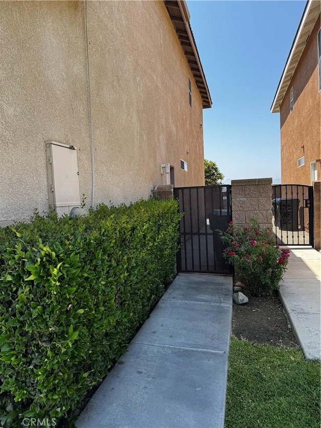 12369 Kern River Dr, Eastvale, CA 91752 - view of home's exterior with a gate and stucco siding