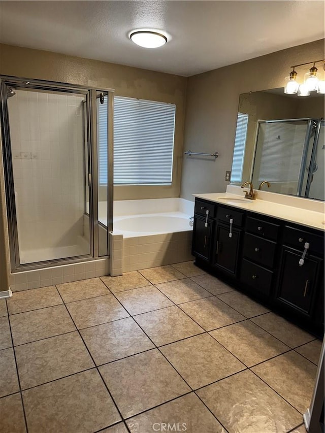 12369 Kern River Dr, Eastvale, CA 91752 - bathroom with double vanity, a bath, a shower stall, and tile patterned floors