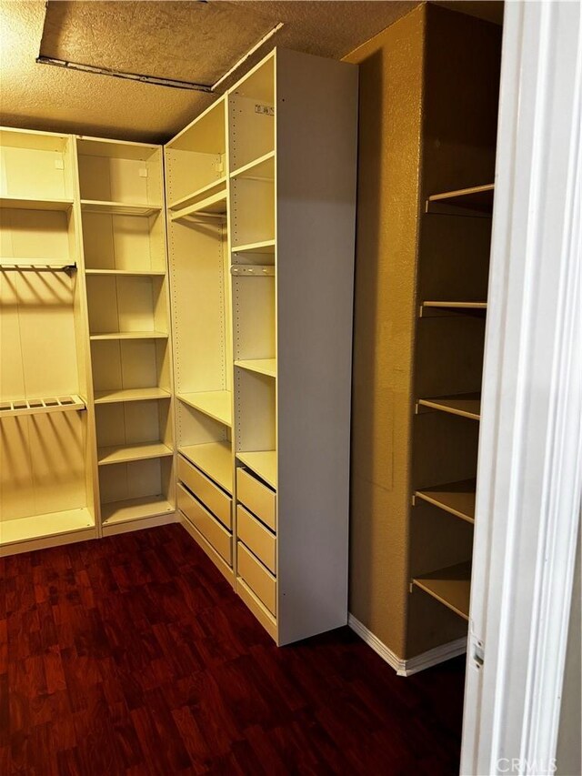 12369 Kern River Dr, Eastvale, CA 91752 - walk in closet with dark wood finished floors