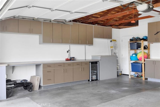 garage with beverage cooler and a garage door opener
