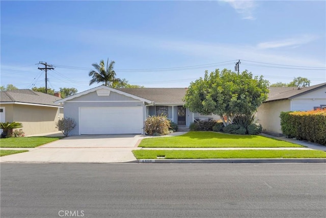view of front of property with concrete driveway, a front lawn, and a garage