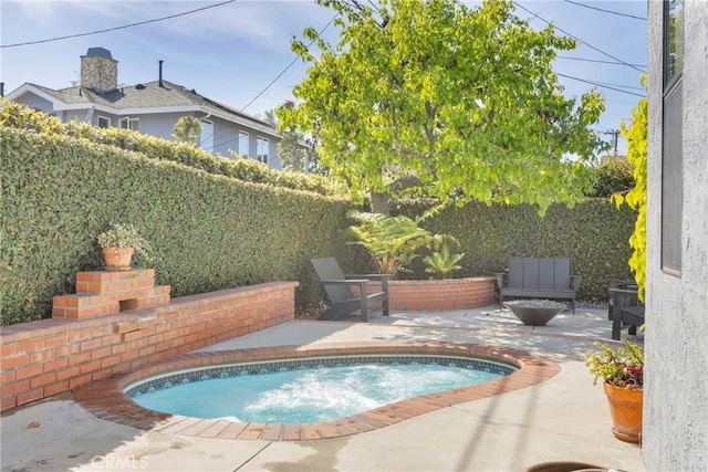 view of swimming pool with a fenced backyard and a patio area