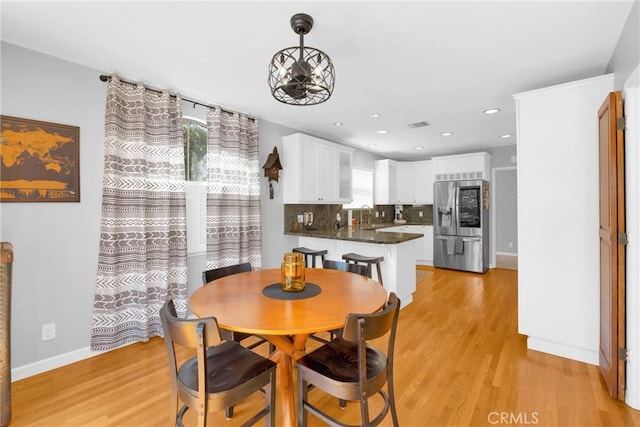 dining room with light wood-style floors, baseboards, recessed lighting, and visible vents