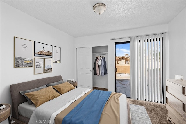carpeted bedroom featuring a closet and a textured ceiling