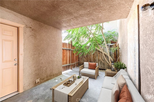 view of patio / terrace featuring an outdoor living space and fence