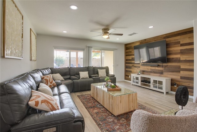 84105 Tramonto Way, Indio, CA 92203 - living room with a ceiling fan, light wood-style flooring, recessed lighting, visible vents, and wooden walls