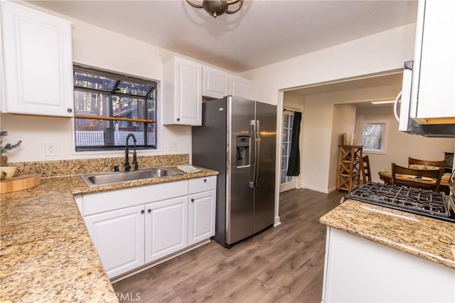 758 Elm St, Big Bear Lake, CA 92315 - kitchen featuring stove, wood finished floors, a sink, stainless steel fridge with ice dispenser, and white cabinetry