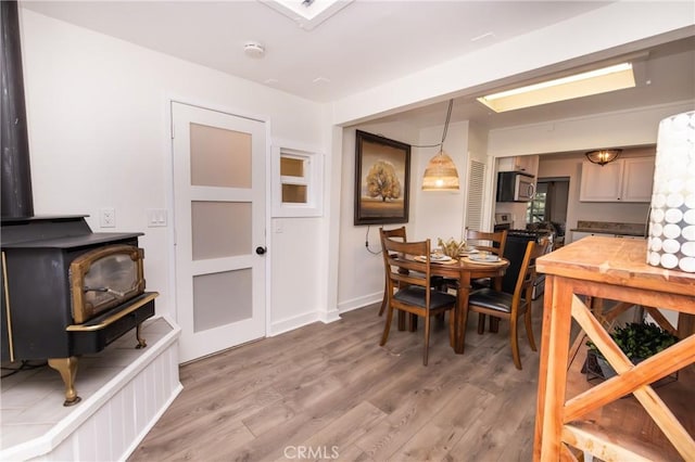 758 Elm St, Big Bear Lake, CA 92315 - dining space featuring a wood stove and light wood finished floors