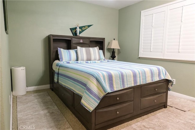 carpeted bedroom featuring baseboards