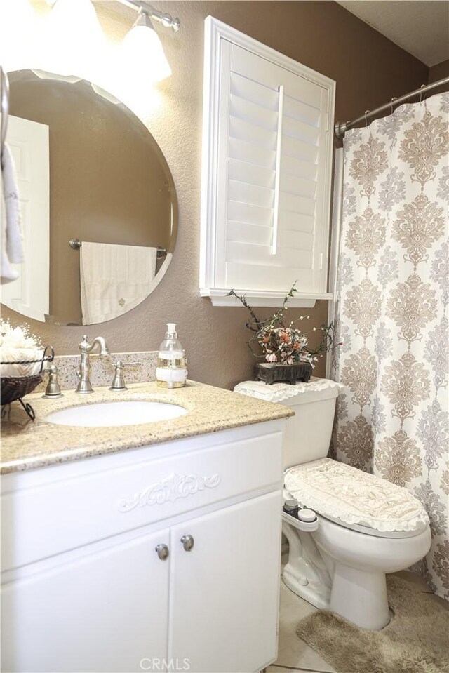 bathroom with vanity, a shower with shower curtain, tile patterned floors, and toilet