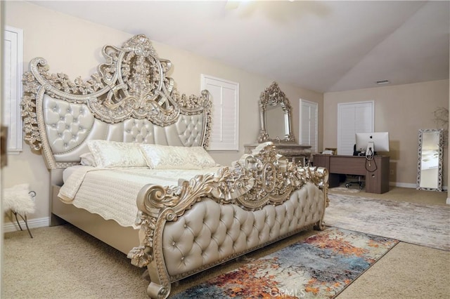 bedroom featuring baseboards, visible vents, vaulted ceiling, and carpet