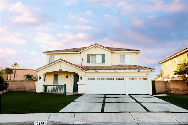 traditional home featuring fence, an attached garage, stucco siding, a tiled roof, and driveway