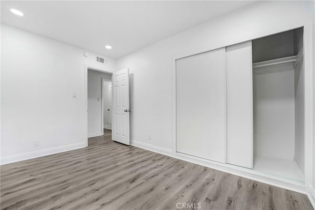 21733 Tuba St, Chatsworth, CA 91311 - unfurnished bedroom with visible vents, baseboards, wood finished floors, and a closet