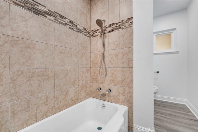 21733 Tuba St, Chatsworth, CA 91311 - full bathroom featuring baseboards, toilet, wood finished floors, and shower / washtub combination