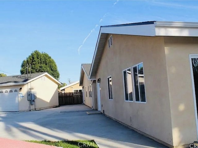 21733 Tuba St, Chatsworth, CA 91311 - view of property exterior featuring stucco siding, an outdoor structure, fence, and a patio