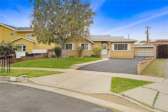 21733 Tuba St, Chatsworth, CA 91311 - view of front of home with a front lawn, stucco siding, driveway, and fence
