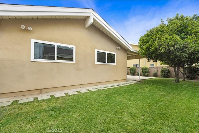 21733 Tuba St, Chatsworth, CA 91311 - view of property exterior featuring stucco siding, a patio area, fence, and a yard