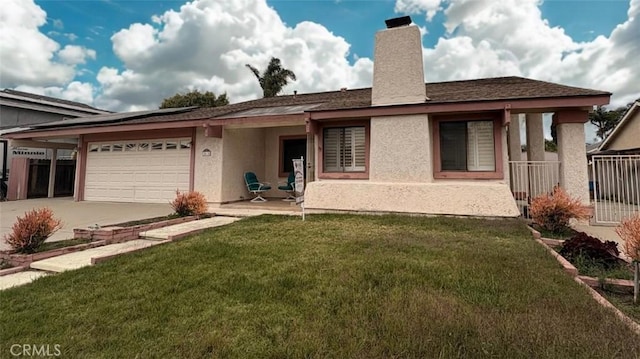 ranch-style house with driveway, a chimney, a front yard, an attached garage, and stucco siding