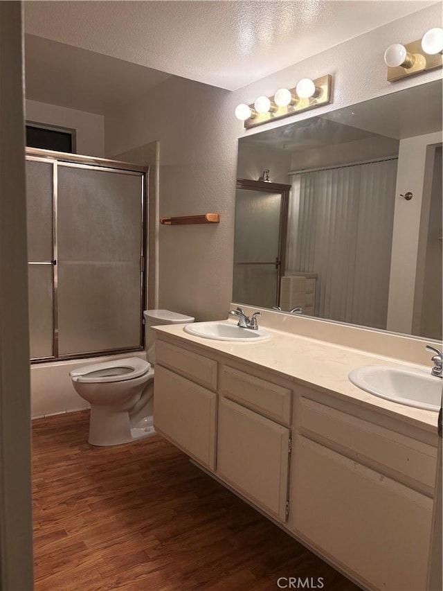 2615 Shalimar St, Camarillo, CA 93010 - bathroom featuring double vanity, wood finished floors, combined bath / shower with glass door, and a textured ceiling