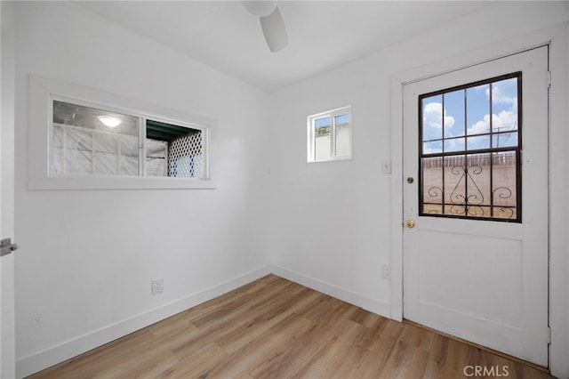 11867 S San Pedro St, Los Angeles, CA 90061 - doorway to outside with a ceiling fan, baseboards, and light wood-style floors