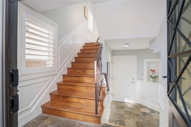 617 Crest Dr, Manhattan Beach, CA 90266 - foyer entrance with a decorative wall, stairway, stone finish floors, and wainscoting
