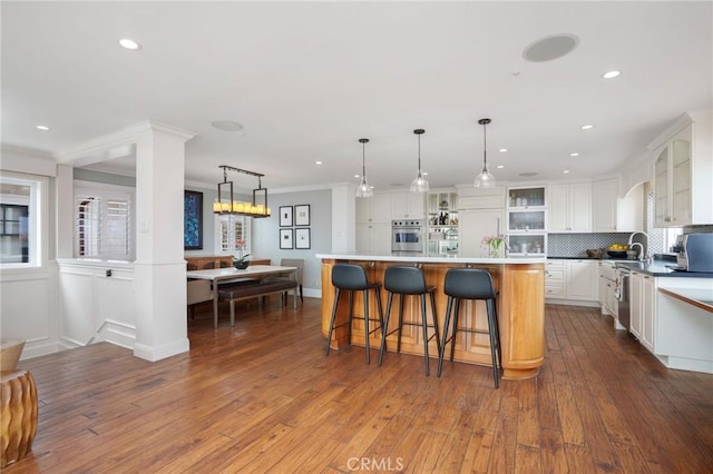617 Crest Dr, Manhattan Beach, CA 90266 - kitchen with stainless steel oven, recessed lighting, white cabinets, glass insert cabinets, and hardwood / wood-style floors