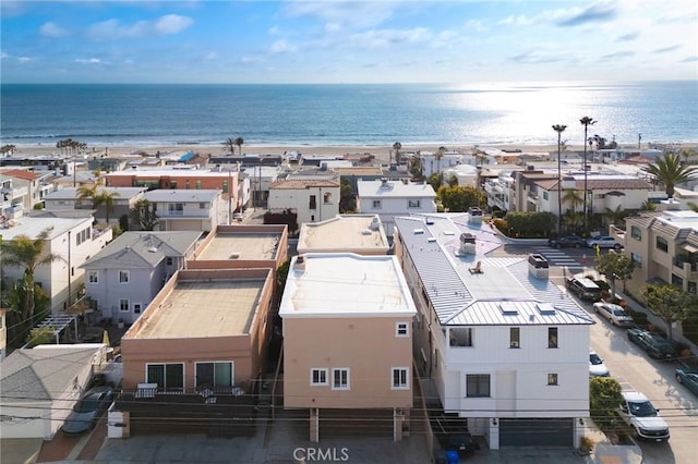 birds eye view of property featuring a beach view and a water view