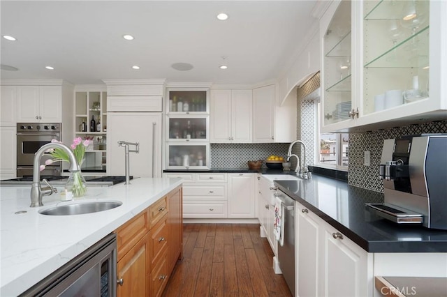 617 Crest Dr, Manhattan Beach, CA 90266 - kitchen featuring stainless steel dishwasher, dark wood-style flooring, decorative backsplash, white cabinets, and recessed lighting